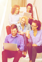 Image showing team with laptop and tablet pc on staircase