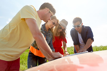 Image showing happy friends with map and car searching location