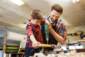 Image showing father and son with drill working at workshop