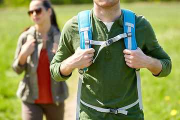 Image showing close up of couple with backpacks hiking outdoors