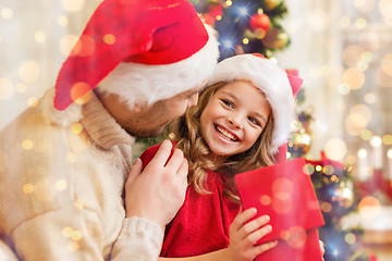 Image showing smiling father and daughter opening gift box