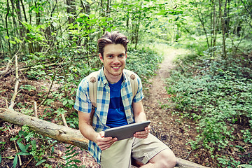 Image showing happy man with backpack and tablet pc in woods