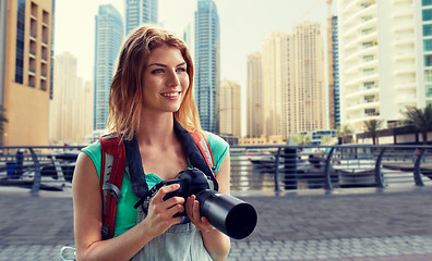 Image showing woman with backpack and camera over dubai city