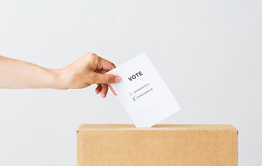 Image showing man putting his vote into ballot box on election