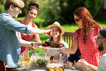 Image showing happy friends having dinner at summer garden party