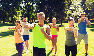 Image showing group of friends or sportsmen exercising outdoors