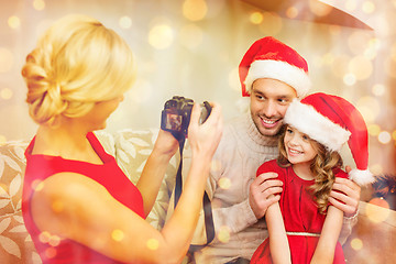 Image showing mother taking picture of father and daughter