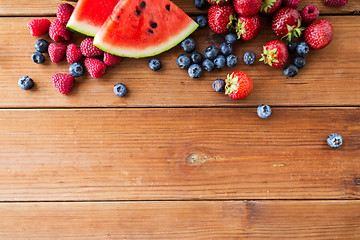 Image showing close up of fruits and berries on wooden table