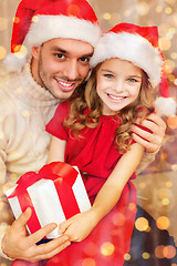 Image showing smiling father and daughter holding gift box