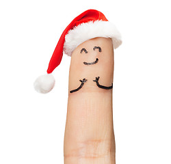 Image showing close up of one finger in santa hat