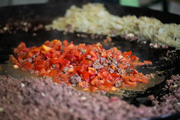 Image showing vegetables frying on big wok pan at street market