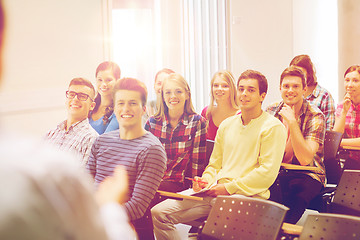 Image showing group of students and teacher with notebook