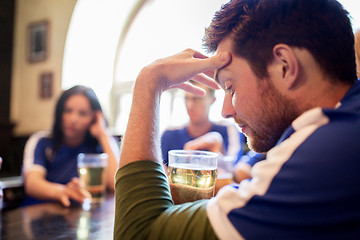 Image showing soccer fans watching football match at bar or pub