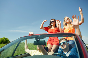 Image showing happy friends driving in cabriolet car