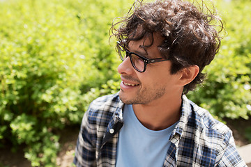 Image showing close up of smiling man in eyeglasses outdoors