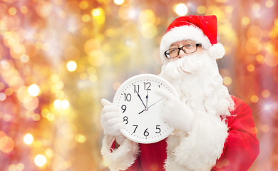 Image showing man in costume of santa claus with clock