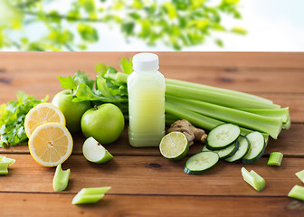 Image showing close up of bottle with green juice and vegetables