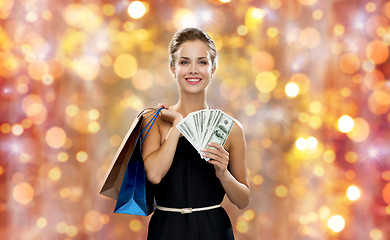 Image showing smiling woman in dress with shopping bags