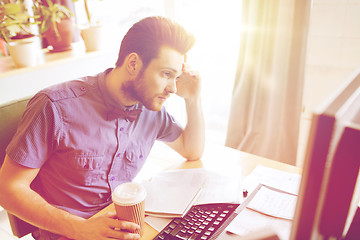 Image showing creative male worker with computer drinking coffee