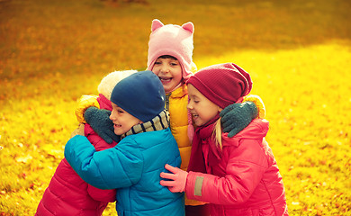 Image showing group of happy children hugging in autumn park