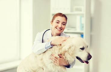 Image showing happy doctor with retriever dog at vet clinic