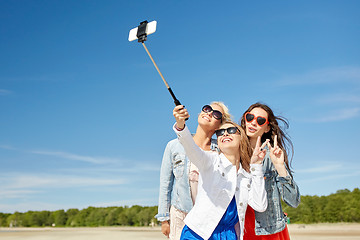 Image showing group of smiling women taking selfie on beach