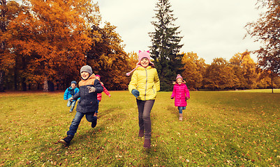 Image showing group of happy little kids running outdoors