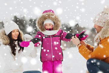 Image showing happy family with child in winter clothes outdoors