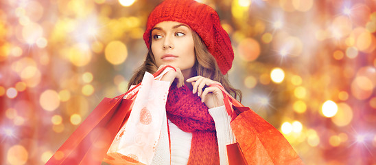 Image showing happy woman in winter clothes with shopping bags