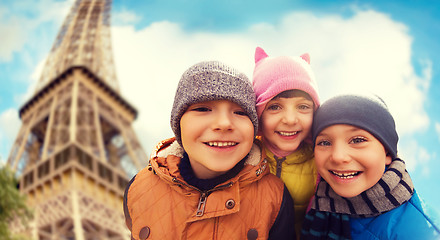 Image showing group of happy children hugging over eiffel tower