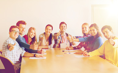 Image showing group of smiling students with hand on top