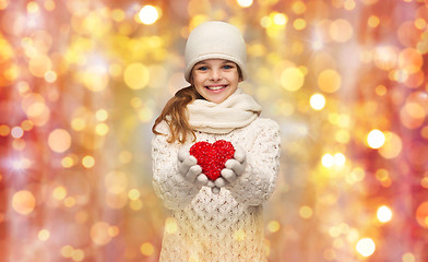 Image showing girl in winter clothes with small red heart