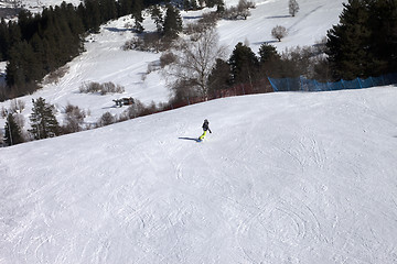 Image showing Snowboarder on ski slope at sun winter day