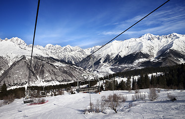 Image showing Chair-lift and ski slope in snow winter mountains at nice sun da