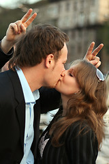 Image showing Young beautiful couple kisses. funny picture