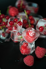 Image showing Frozen berries on wooden table