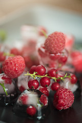 Image showing Frozen berries on wooden table