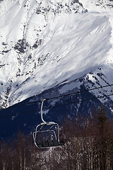 Image showing Ski lift in snow mountains at sun winter day