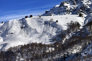 Image showing Off-piste slope with track from avalanche on sun day