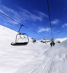 Image showing Chair-lift at ski resort in sun winter day