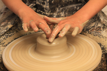 Image showing working on spinning wheel