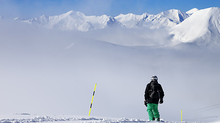 Image showing Panoramic view on snowboarder on snowy slope with new fallen sno