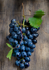 Image showing Bunch of red grapes on wooden background