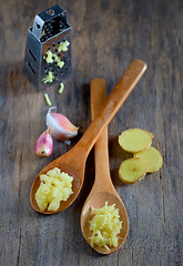 Image showing garlic and ginger in wooden spoons