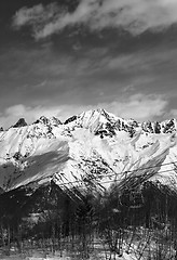 Image showing Black and white ski lift in snow mountains at nice winter day