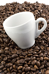 Image showing Classic white espresso cup on coffee beans