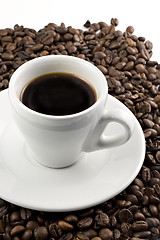 Image showing Classic white espresso cup on coffee beans