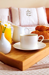 Image showing Breakfast on a bed in a hotel room