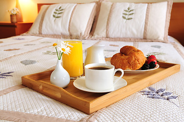 Image showing Breakfast on a bed in a hotel room