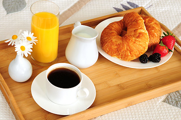 Image showing Breakfast on a bed in a hotel room